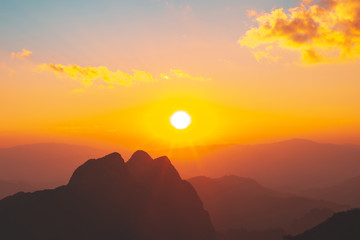 Focused on top of mountain at Sunset or evening time with blue sky and sunray or sunbeam with clouds at Doi Luang Chiang Dao, Chaingmai, Thailand. Asia.