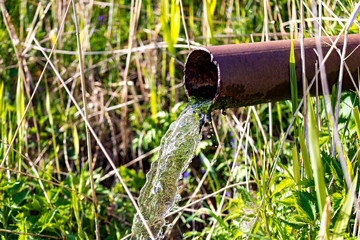 Water running from rusted metal pipe