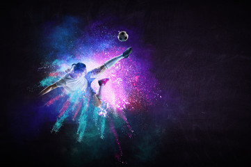 Boy playing soccer hitting the ball