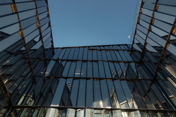 glass facades of modern office buildings and reflection of blue sky  © cmirnovalexander