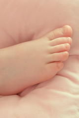 little baby foot of two year old child. The concept of family.