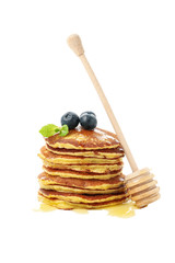 Tasty pancakes with honey and fruit isolated on white background