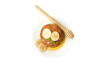 Tasty pancakes with banana and honey isolated on white background