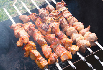 Traditional skewers on skewers and barbecue. Springtime outdoor recreation. Grilled meat.