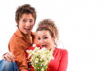  happy young couple in love with a flower bouquet standing together on white background

