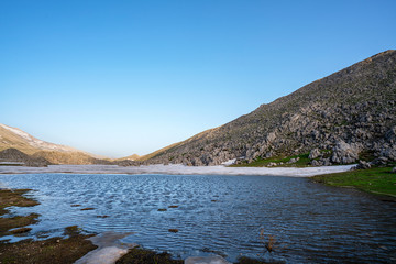 Lake Egrigol (eğrigöl), a hidden gem sitting at 2,350 meters in the foothills of Geyik Mountain in Antalya province, Surrounded by 3 or 4 meters of snow on one side and mountain wild flowers