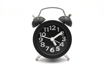 Black alarm clock isolated on white. Alarm clockis a clock that is designed to alert an individual or group of individuals at a specified time.

