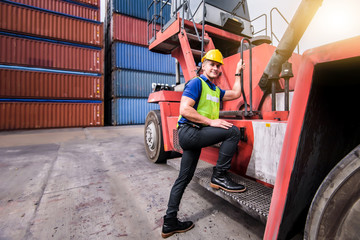 Fototapeta na wymiar Confident Caucasian man engineer wearing yellow safety helmet and check for control loading containers box from Cargo freight ship for import and export, shipping logistic transport concept.