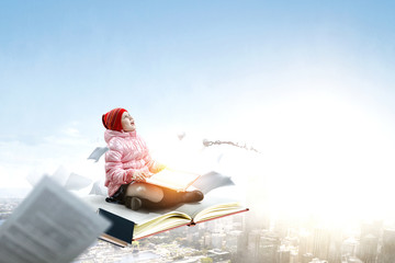 Little girl reading a book