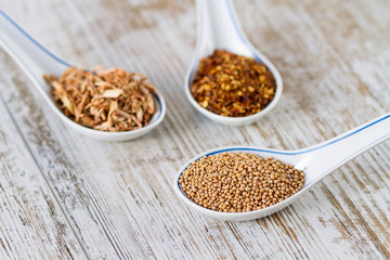 Spices and herbs in porcelain spoons