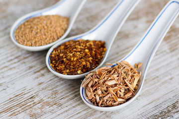 Spices and herbs in porcelain spoons