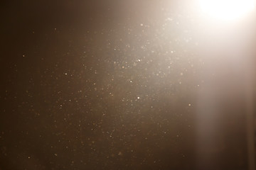golden colour dust particle on black background