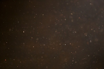 golden colour dust particle on black background