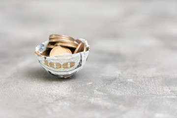 100 dollar piggy bank with coins filled. Gray background
