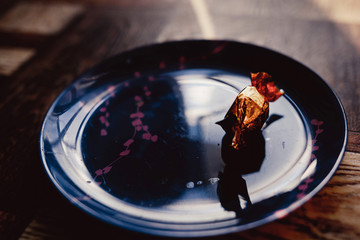 chocolate bright candy on a plate beautiful dish with a red pattern dark background and rays of light