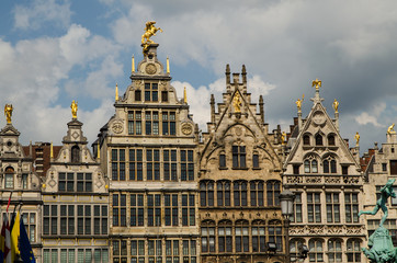 Fototapeta na wymiar Antwerp, Flanders, Belgium. August 2019. On a beautiful sunny day detail of the facades of the guild houses in the town hall square. Elegant gilding embellishes the Renaissance architecture.