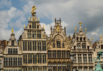 Fototapeta na wymiar Antwerp, Flanders, Belgium. August 2019. On a beautiful sunny day detail of the facades of the guild houses in the town hall square. Elegant gilding embellishes the Renaissance architecture.