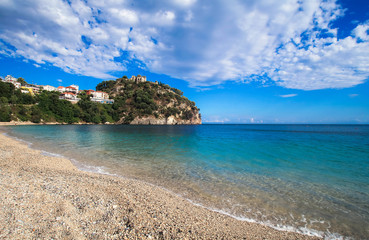 Fototapeta na wymiar A long beach with view on fortress in Parga, Greece