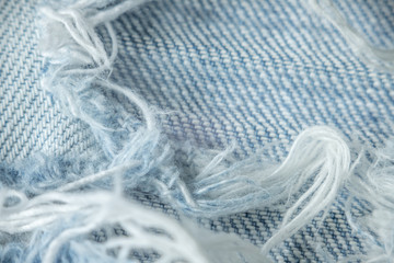 Texture macro with denim of white-blue color with protruding fibers and threads, lacerated, grunge....