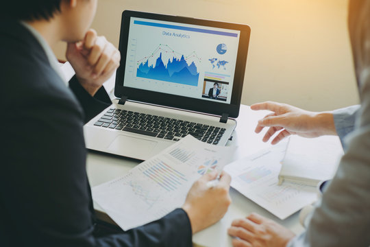 Two businessman investment consultant data analyzing company financial report balance statement working with documents graphs. Concept picture for stock market, office, tax, and project. - Powered by Adobe