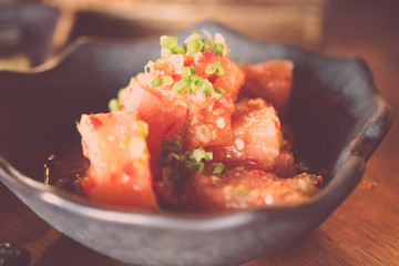 Salmon sashimi spicy salad mixed vegetable in bowl