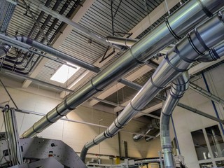 Dust and paper trimming collection ducts at the end of a printing press