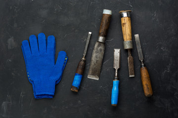 Carpenter Tools and working gloves on dark background. Minimal black.