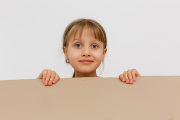 Cute little girl standing in large cardboard box, wanting to play hide-and-seek
