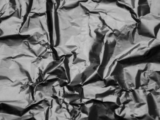 Silver metallic crumpled foil texture background