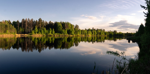 Evening landscape on a lake with a forest on the shore, Russia, Ural