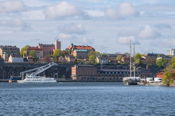 Fototapeta premium Harbor view with boats and ships at the district Södermalm a sunny spring morning in Stockholm. 