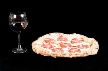 real italian pizza margherita with pork loin mozzarella cheese, in a black background from the top...