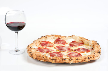 real italian pizza margherita with pork loin mozzarella cheese, in a white background whit a glass of delicious Italian red Chianti wine
