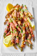 Keto diet bacon wrapped asparagus on a white plate