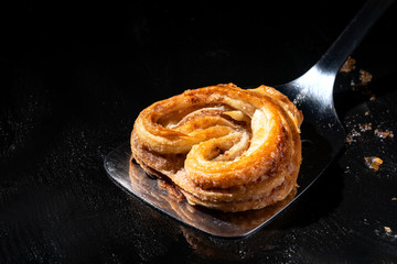 Sweet cinnamon bun on a baking sheet