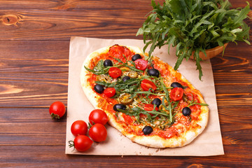 Italian pepperoni pizza pinza with olives and arugula