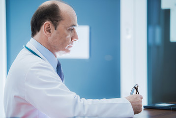 Fototapeta premium Medical Doctor Sitting At Desk In Office.