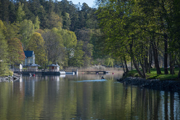 Fototapeta premium Landscape view at the waterfront of the lake Lännerstasundet and Stockviken i the district Nacka of Stockholm a sunny spring morning.