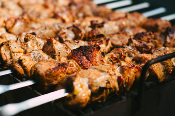 Grilled kebab. Juicy meat on the coals. Traditional Russian and Ukrainian cuisine. Marinated kebab is grilled on charcoal.