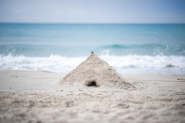 Holiday concept with sandcastle on the seaside