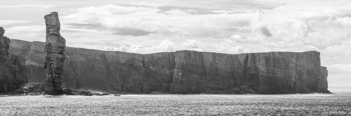 black and white panorama of Old Man of Hoy, a tall sandstone stack at the coast between Stromness and Scrabster at Orknay in Scotland, Uk
