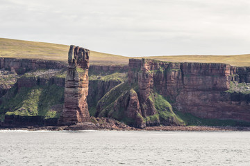 ocean view of the Old Man of Hoy, a tall sandstone stack at the coast between Stromness and Scrabster at Orknay in Scotland, Uk. Famous British climbing place