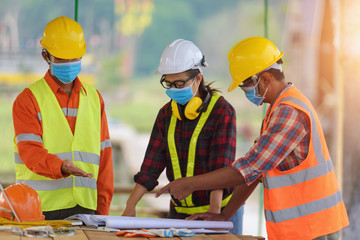 Corona or Covid-19 wear masks during the design of construction. New normal.Industrial engineering team wears a COVID 19 protective mask. Workers wear a quarantine face mask.