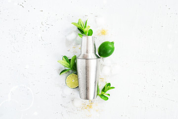 Metal shaker and ingredients for mojito cocktail