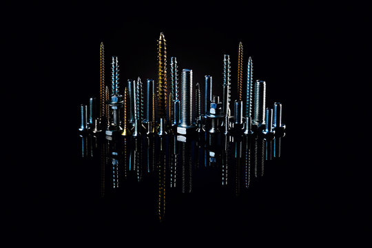 The city at night from small screws and bolts. Advertising photo of materials and products for construction.