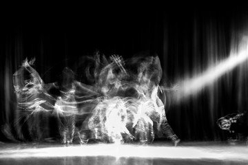 An artistic dancer in a theater shot with a slow shutter speed in order to achieve the desired...