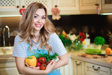 Beautiful young woman is preparing vegetable salad in the kitchen. Healthy Food. Vegan Salad. Diet. Dieting Concept. Healthy Lifestyle. Cooking At Home.