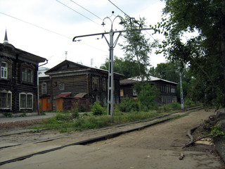 Naklejka premium Wooden buildings and a tram track in the 414 year old Siberian city of Tomsk in Russia
