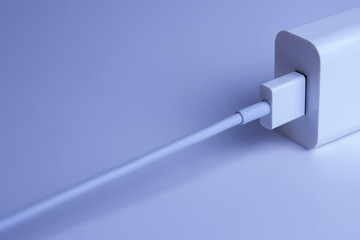 usb connection in the charger for a smartphone on a blue background
