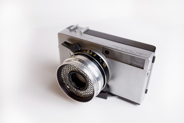 Soviet film retro camera with lens against white background